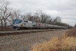 Amtrak 90 leads a train west with three private railcars in tow